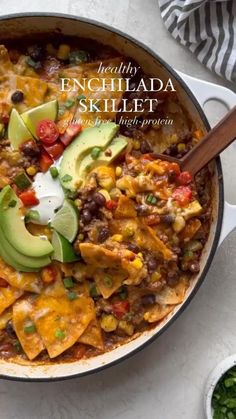 a skillet filled with mexican food and topped with avocado