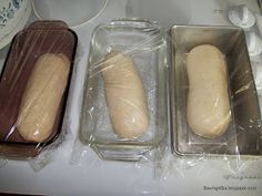 three loafs of bread sitting in plastic containers