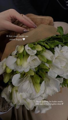 a bouquet of white flowers sitting on top of a car seat