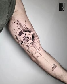 a man's arm with an abstract tattoo on it