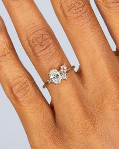 a woman's hand with an engagement ring on it