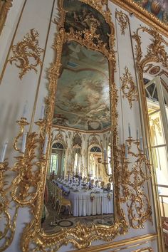 an ornately decorated dining room with large mirror