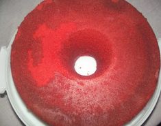 a white plate topped with a red frosted cake