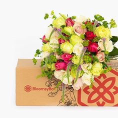 a bouquet of flowers sitting on top of a box