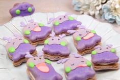 purple and green decorated cookies on a plate