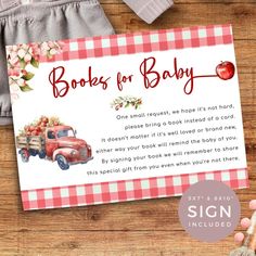 a baby shower card with an old truck and apples on it, sitting next to a bottle