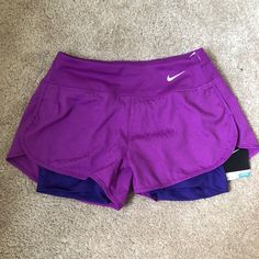 Purple 2-In-1 Dri-Fit Shorts. Spandex Underneath. Zipper Ouch In Back. Stretch Nike Shorts In Purple, Nike Stretch Athletic Shorts In Purple, Stretch Purple Nike Athletic Shorts, Nike Purple Shorts, Nike Purple Athletic Stretch Shorts, Nike Stretch Purple Shorts, Nike Purple Bottoms With Built-in Shorts, Purple Moisture-wicking Athletic Shorts For Running, Purple Moisture-wicking Running Shorts