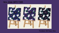 three small easels with blue and purple flowers on them, one is holding an easel