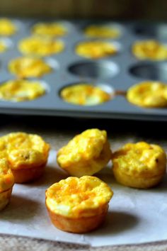 several mini muffins sitting on top of a table next to a baking pan