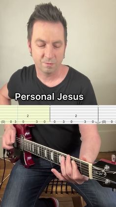 a man sitting down playing guitar with the words personal jesus on it in front of him