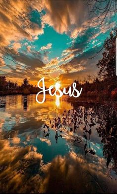 the word jesus is written in front of a beautiful sunset over a body of water