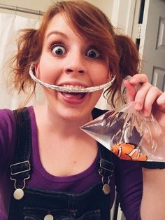 a woman with a fake moustache on her face holding a plastic bag in front of her mouth