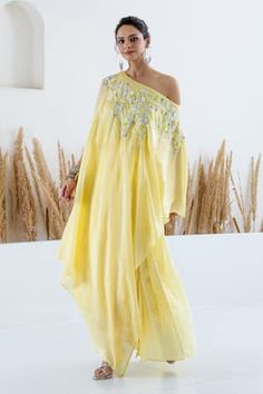 Yellow cape with sequin and beads embroidery in floral motifs. Paired with printed pleated skirt. - Aza Fashions Summer Hand Embellished Designer Sets, Spring Embellished Dresses With Traditional Drape, Bohemian Sequin Sets For Summer, Bohemian Hand Embellished Georgette Dresses, Bohemian Style Sequined Sets For Summer, Hand Embellished Georgette Dresses For Summer, Hand Embellished Georgette Dress For Navratri, Yellow Embellished Dress For Navratri, Navratri Hand Embellished Georgette Dress