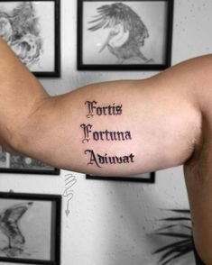 a man with a tattoo on his arm that says fortes fortma adunat