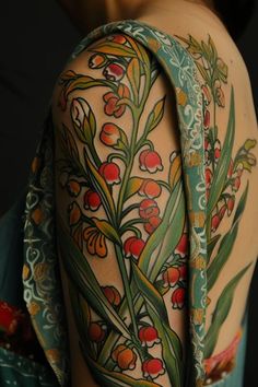 a woman with tattoos on her arm and shoulder