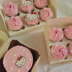 hello kitty cupcakes in pink frosting are on the table next to each other