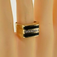 Vintage 14K Yellow Gold Black Onyx and Diamond Ring, 1/2 ct diamond, 2 flat panels of black onyx flank, 6 round channel set diamonds, Ring size 11, Circa 1960, 9.3 grams SKU # BB262R04 Most rings are sizable for a small fee. If the ring you are considering is the incorrect size contact us for a quote. This listing contains photographs of the actual item you will receive. Our items are in excellent condition with little or no signs of wear and many are one of a kind pre-owned estate finds. Please Olivia Ross, Fine Jewelry Designers, Blue Topaz Ring, Topaz Ring, Pink Tourmaline, Black Onyx, Blue Topaz, Tourmaline, Onyx