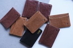 several wallets are laid out on the table with one empty card holder in front of them