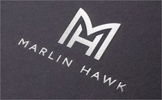 the marlin hawk logo is shown in white on black canvas fabric, which also has an embossing pattern