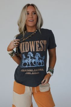 No boho closet is complete without the perfect graphic tee, and the Midwest Fortune Graphic Tee is it! So cool, you won’t want to miss out! Comfortable, mineral-washed, Cotton tee shirt fabric Relaxed and slouchy silhouette for ultimate comfort Classic crew neckline with dropped shoulders and loose short sleeves So cool Western Inspired Running Wild Horses with "MIDWEST - Fortune Favors the Bold" print Pair with: Eye Of The Sun Padded Bralette, The Signature Flare and Shoreline Platform Sandals. Bohemian Crew Neck Washed Tops, Bohemian Washed Crew Neck Tops, Vintage Washed T-shirt For Fall, Bohemian Distressed Crew Neck Top, Fall Graphic Tee With Vintage Print, Bohemian Acid Wash Crew Neck Top, Free-spirited Cotton Crew Neck T-shirt, Bohemian Distressed Short Sleeve T-shirt, Bohemian Washed Short Sleeve T-shirt