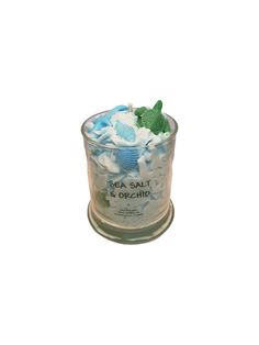 a glass container filled with blue and white candies on top of a wooden stand