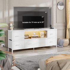 a flat screen tv sitting on top of a white entertainment center in a living room