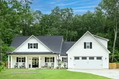 a white house with black shutters in the front yard