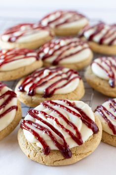 cookies with white and red icing sitting on a cooling rack, ready to be eaten