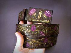 "\"A gift of a thistle\" - this hand tooled leather belt with thistle ornament would definitely attract attention. It reminds me of Scotland, its' hills, lakes, Highlands, Lowlands, cliffs, windy valleys and faeries dancing in the thistle fields... One doesn't have to be Scott to love the atmosphere of Scotland! Thistles symbolise a strong personality and vitality in general and if you're a tough lady (or a gentleman who's married to one) - this belt is waiting for you! ;) Depth of the colours i Leatherworking Ideas, Runway Clothes, Iridescent Fashion, Boho Leather Jewelry, Leather Painting, Leather Creations, Leather Patterns, Tooled Leather Belts, Leather Ideas