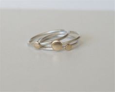 Perfect everyday Stacking Rings!Each dot ring is individually handmade from sterling silver and brass, and finished with a brushed finish. The dots are 4mm and 3mm. The three rings can be worn together or individually or stacked with other rings as well.  These rings are also available with Copper dot or Silver dots, on silver rings.Each ring can be made in different sizes if requested at checkout.Comes Gift Wrapped!++++++++++++++++++++++++++++++++++++++++++++++++++++++++++++++++MADE TO ORDERPle Handmade Sterling Silver Stackable Rings In Yellow Gold, Handmade Gold Stackable Rings In Sterling Silver, Silver Dainty Brass Rings, Dainty Silver Brass Rings, Handmade Minimalist Brass Stackable Rings, Silver Brass Stackable Rings For Promise, Rings Silver And Gold, Stacking Rings Silver, Rings Minimal