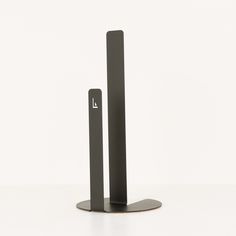 a pair of black bookends sitting on top of a white table