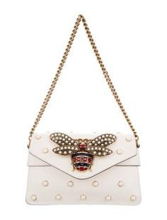 #GUCCI | From the Fall/Winter 2015 Collection. Creme leather Gucci Broadway Mini bag with gold-tone hardware, red and multicolor Web nylon shoulder strap, single chain-link top handle, faux pearl embellishments throughout, faux pearl and multicolor crystal bee embellishment at front face, blush leather interior, single slit pocket at interior wall and flap with magnetic snap closure at front. Includes dust bag. Shop authentic designer handbags by Gucci at The RealReal. Angel Bag, Bags Online Shopping, Authentic Designer Handbags, Bag Shop, Interior Wall, Gucci Handbags, Leather Mini, Luxury Items, Fashion Handbags