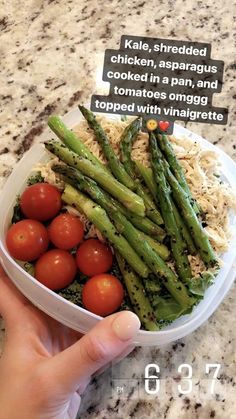 a person holding a plastic container filled with vegetables