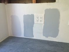 the walls are being painted in an empty room with electrical outlets on each one side