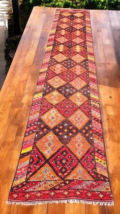 a long rug is sitting on top of a wooden table