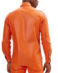 Own Your Bold and Stand Out in Style.Crafted with meticulous attention to detail by artisans with over five decades of experience, this fiery orange leather shirt isn't just an article of clothing, it's a conversation starter. Made from buttery soft, top-grade sheepskin leather, this shirt feels as luxurious as it looks. The sleek, tailored silhouette flatters your form, while the two flap chest pockets add a touch of functional flair. Effortlessly transition from day to night. Pair it with dark Mens Leather Shirt, Mens Leather Clothing, Mens Leather Pants, Hoodies Mens, Leather Shirt, Orange Leather, Leather Shorts, Trucker Jacket, Distressed Leather