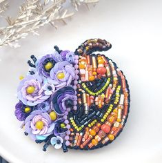 a white plate topped with beads and flowers