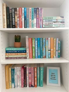 a white book shelf filled with books and a potted plant on top of it