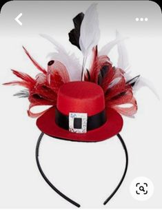 a red hat with white feathers and a black band