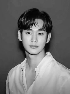 black and white photo of a young man with short hair wearing a button up shirt