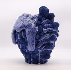 a blue piece of art that looks like corals