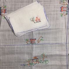 two pieces of cloth with embroidered animals on them