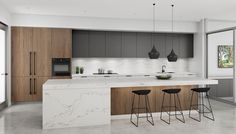 a modern kitchen with marble counter tops and wooden cabinets, along with bar stools