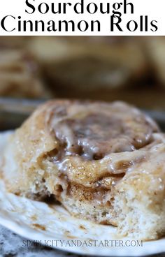 a close up of a cinnamon roll on a plate with the title in the middle