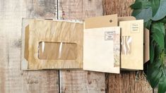 the inside of an open envelope with some papers attached to it on a wooden surface