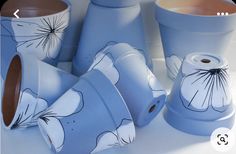 several blue vases with flower designs on them sitting next to each other in front of a white background