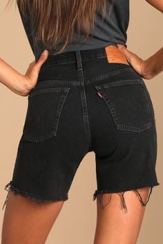 The Levi's 501 Mid Thigh Washed Black Cutoff Denim Shorts offer the classic fit of your 501's with a little added length! These adventure-ready long denim shorts are composed of a medium-weight non-stretch denim (in Levi's Lunar Black wash) and feature a high-waist, longer, mid-thigh cut, and frayed raw hems to finish the look. Belt loops, five-pocket cut, branded top button, and hidden button fly. Leather patch and red logo tag at back. Fit: This garment fits true to size. Length: Mid-thigh. Si Classic Black Jeans For Summer, Levi's Jean Shorts With Frayed Hem, Levi's Fitted Straight Leg Shorts, Fitted Black Jean Shorts With Straight Leg, Black Straight Leg Jean Shorts For Spring, Levi's Classic Jean Shorts, Classic Levi's Jean Shorts, Classic Fitted Cutoff Jean Shorts, Classic Cutoff Shorts For Spring