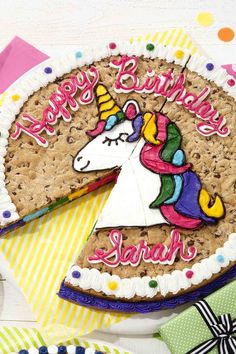 a birthday cake decorated with an image of a unicorn