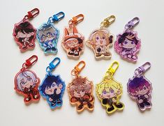 a group of cartoon character shaped keychains sitting on top of a white table