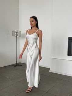 This white elegant dress with straps is crafted from premium dense Italian silk satin, offering a smooth and luxurious feel. Perfect for special occasions or evening events, the dress has a classic silhouette with a length of 118 cm (without straps). The size XS, S, M, L that fits your measurements is listed in the size chart. Please refer to the size chart to see which measurements each size corresponds to. Sizes XL and XXL are made to measure. Please provide your measurements when placing the order so we can create the perfect dress for you. Care Instructions for Silk-Satin Garments: * Hand wash or use a delicate machine cycle at a temperature no higher than 30oC (86oF). * Use mild detergent specifically for delicate fabrics or silk. * Avoid wringing or twisting the fabric to prevent dam White Civil Wedding Dress, White Elegant Dress, 90s Slip Dress, White Satin Dress, White Silk Dress, Civil Wedding Dresses, Silk Satin Dress, White Slip Dress, Silk Satin Fabric